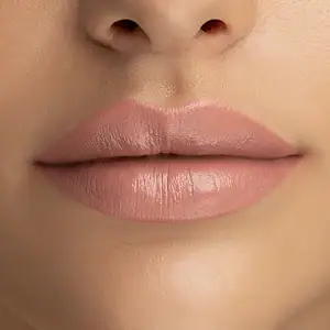 Lippen me të buta dhe të shkëlqyera me produkt kozmetikë për buzë.