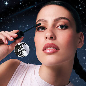 Aktorja aplikon mascara në sytë e saj për një look të qetë dhe të madhërueshëm me sfond cosmic të yj.